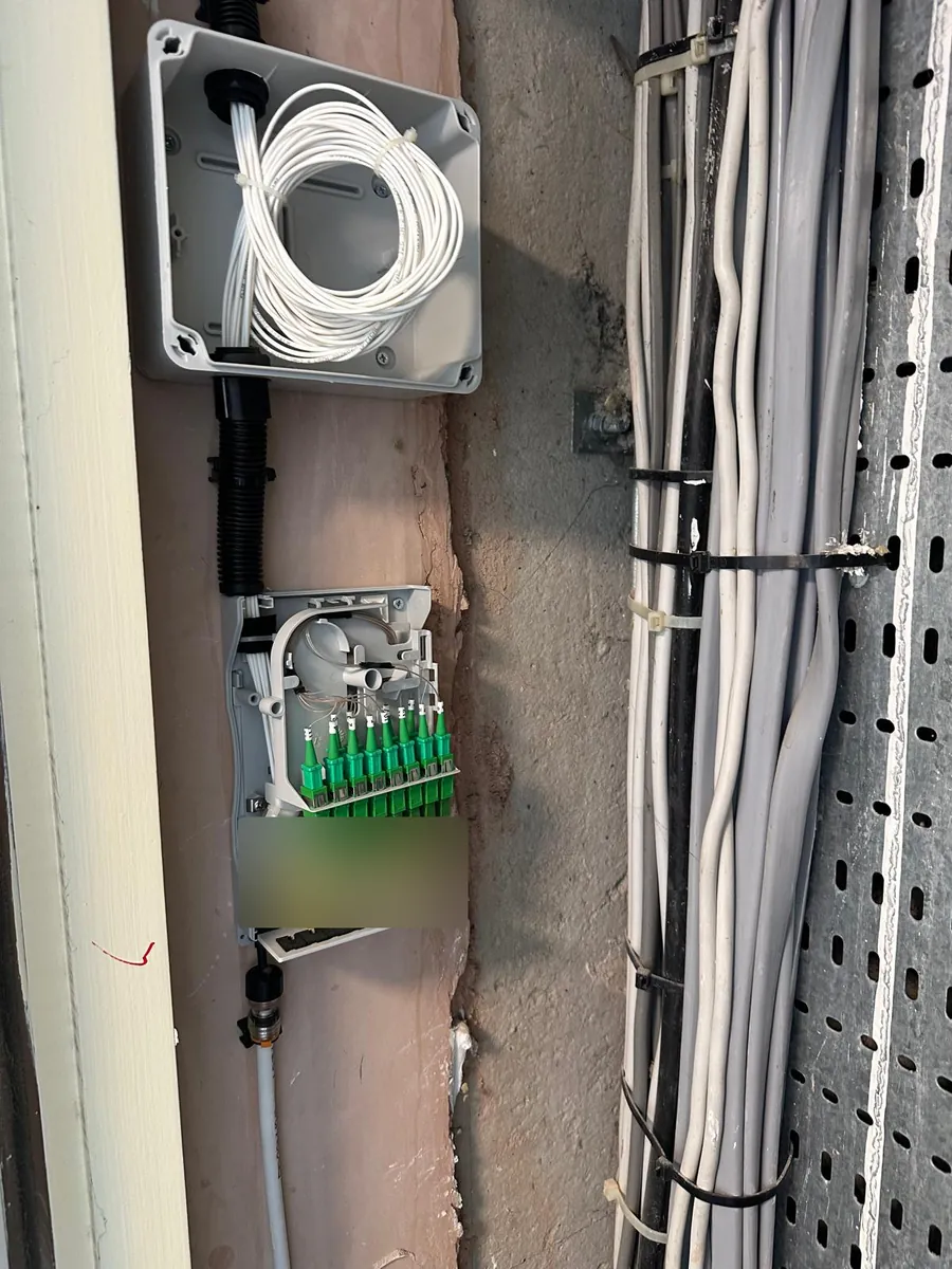 Fibre splitter enclosure beside existing cable tray
